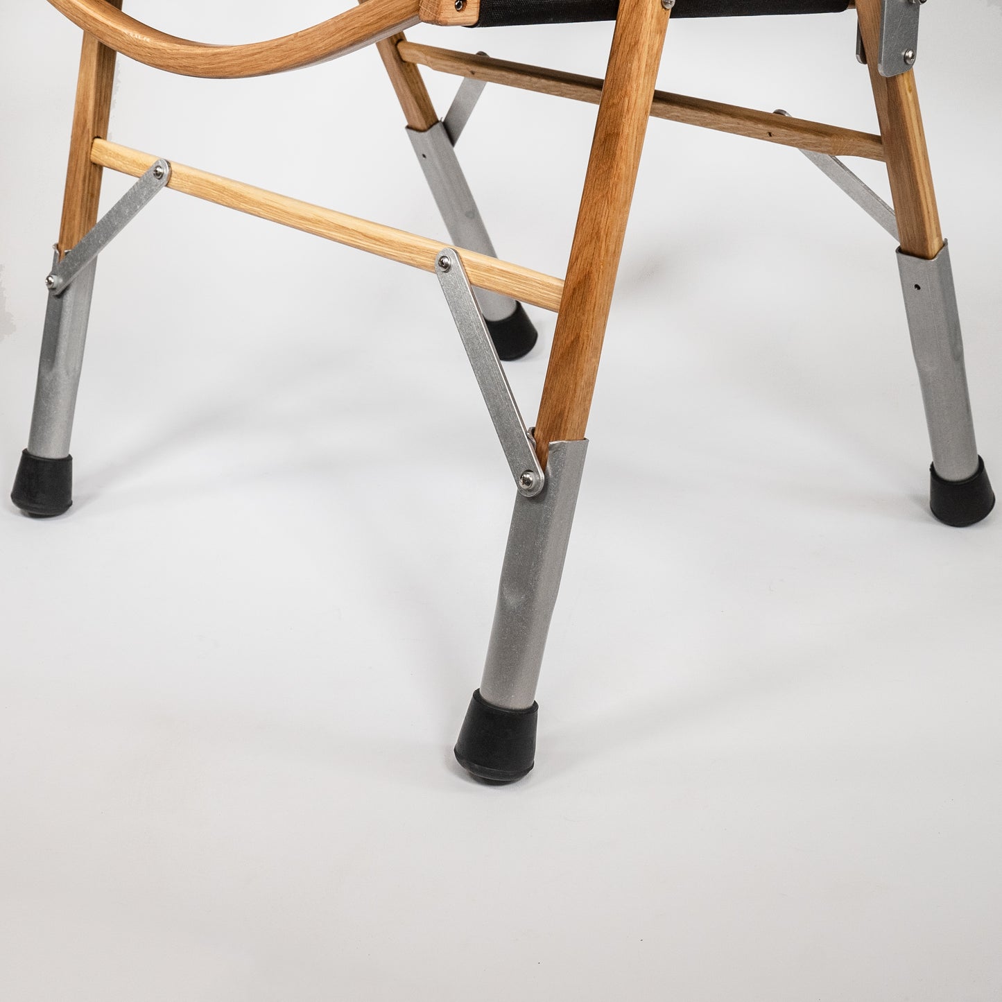 4 aluminium leg extensions mounted on a classic oak kermit chair attachable detachable portability packable handmade wooden furniture camping glamping made in the USA
