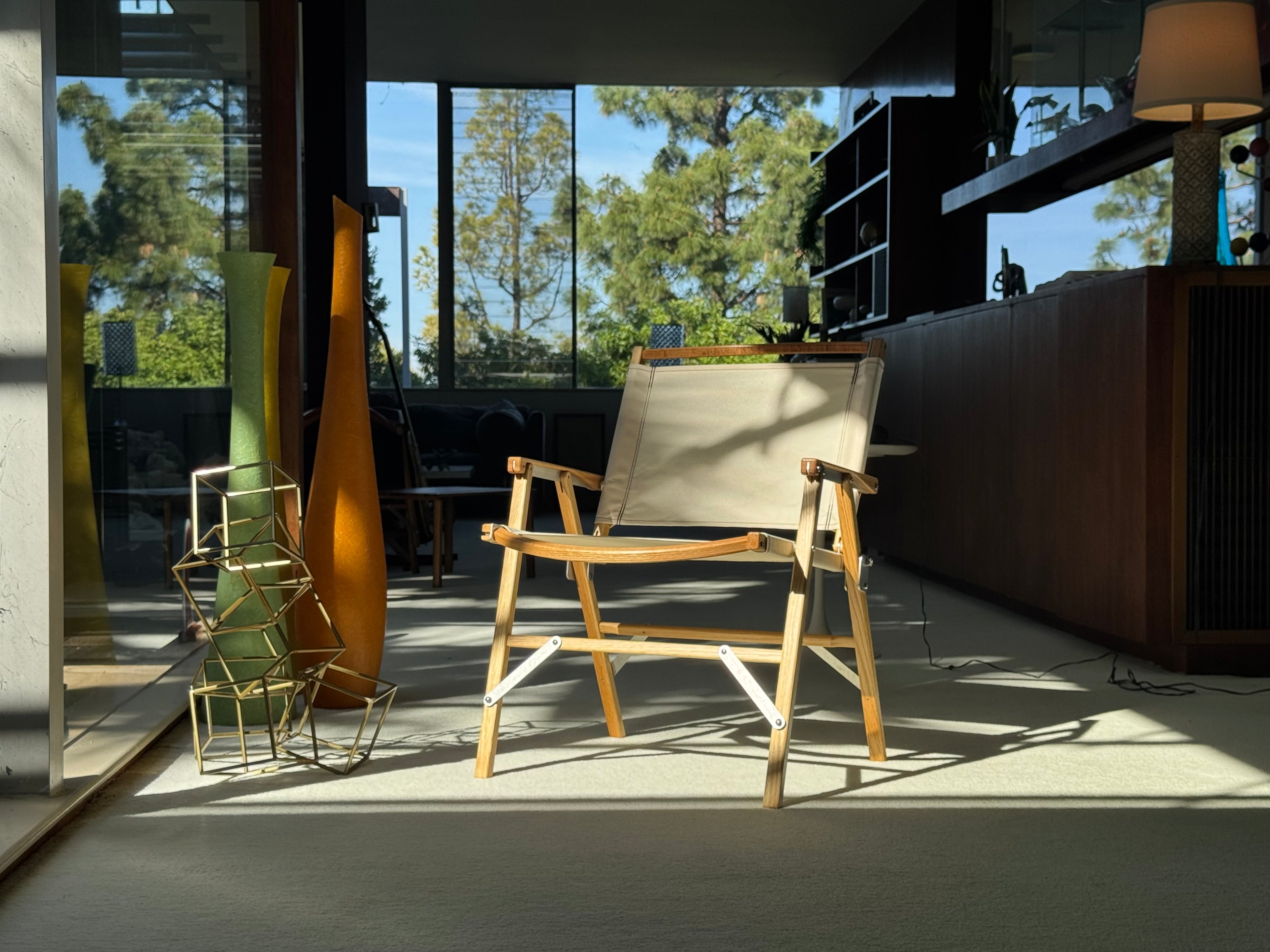 A Classic Oak Taller Folding Kermit Chair in a Richard Neutra designed home with mid century modern objects in the surrounding.