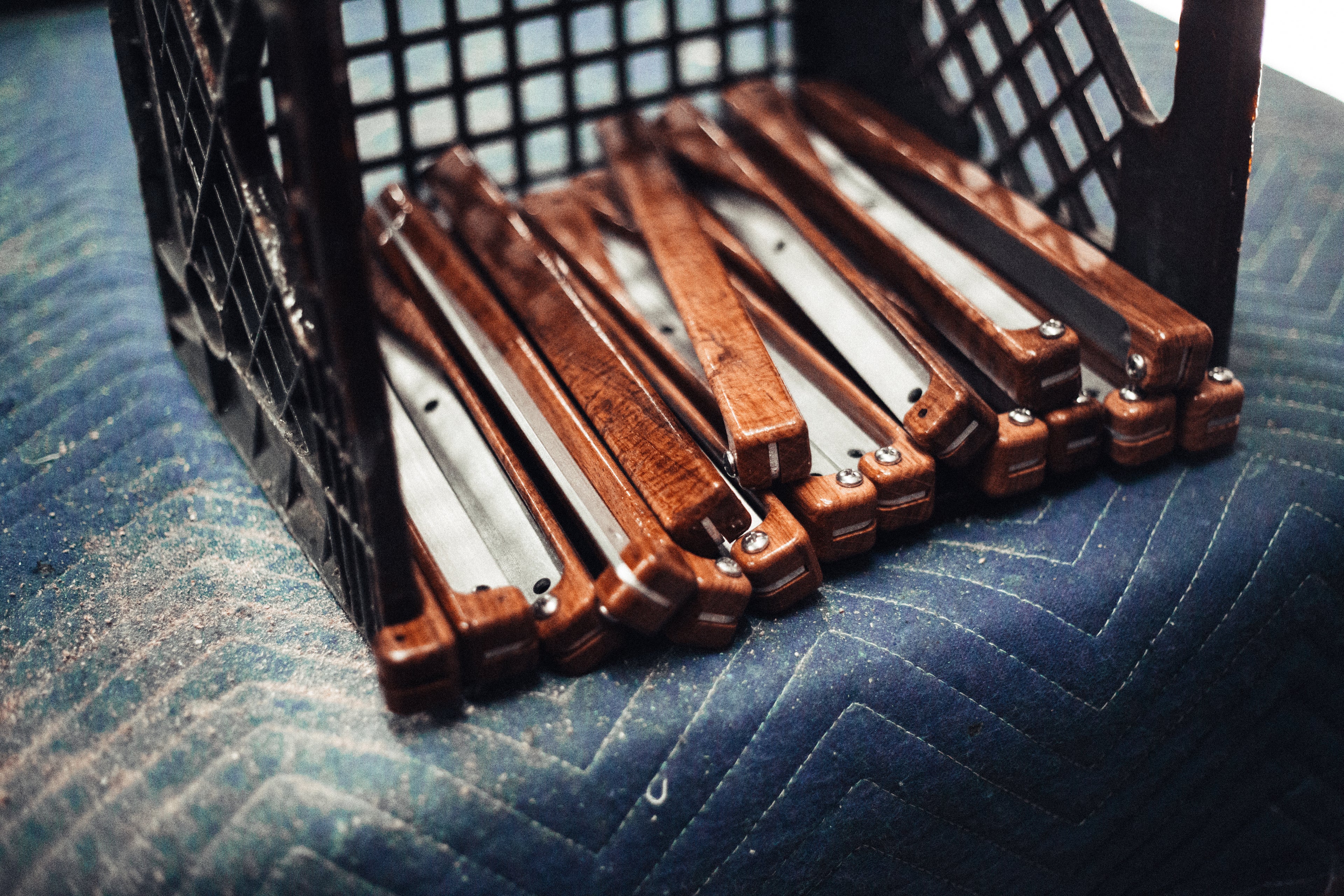 A crate of arm attachments for a Classic Oak Folding Kermit Chair.