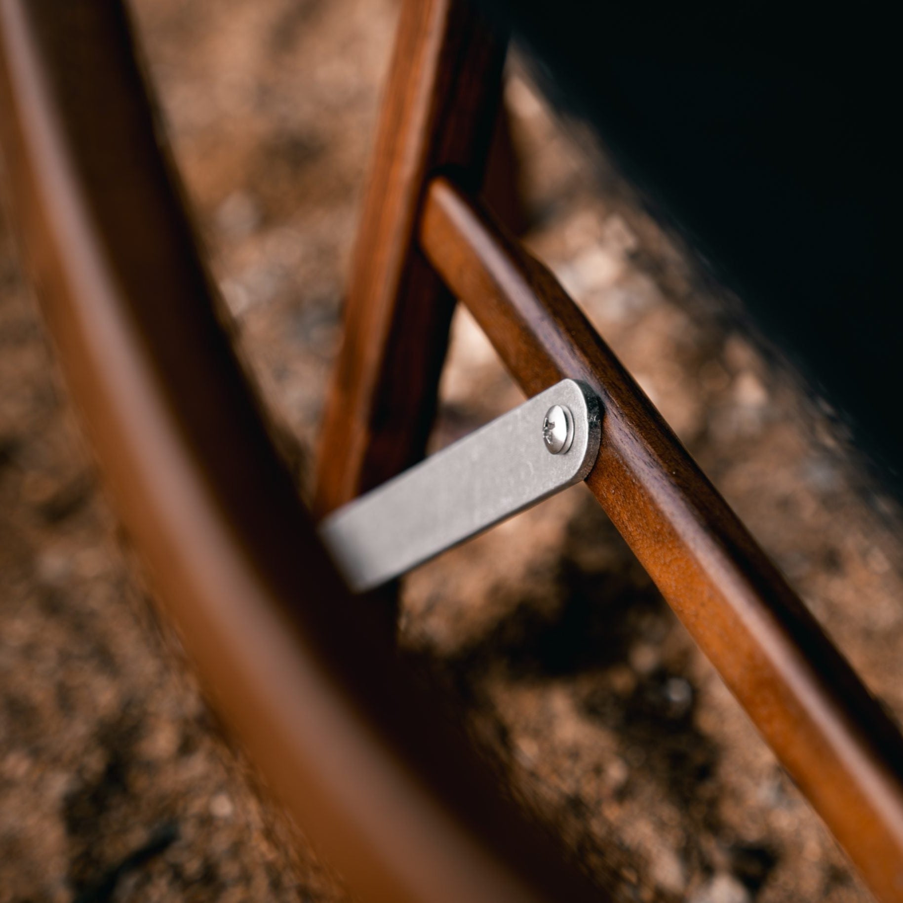 close up photograph of Kermit Chair walnut black fabric handmade camping glamping furniture aluminium hardware long lasting luxury