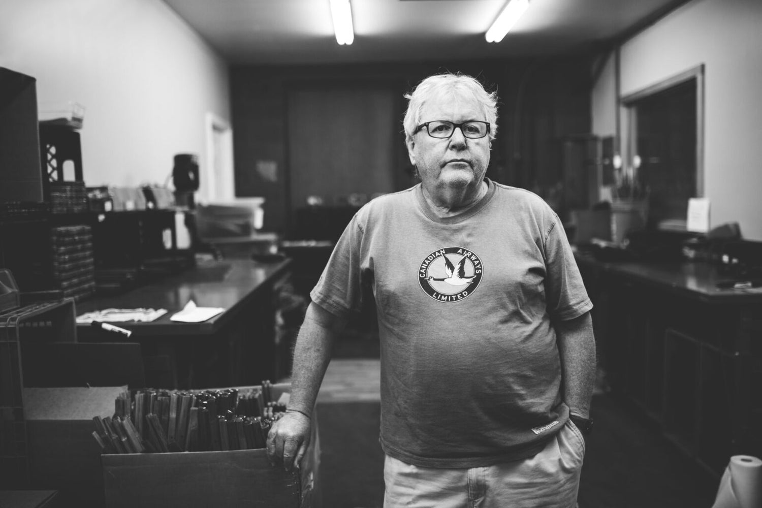 tom sherrill kermit chair owner in his shop in nashville tennessee leaning on a crate of spare parts